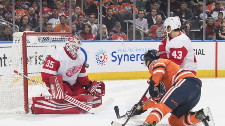 EDMONTON, AB - JANUARY 22: Alex Chiasson #39 of the Edmonton Oilers lets a shot go as Darren Helm #43 and goaltender Jimmy Howard #35 of the Detroit Red Wings defend the net on January 22, 2019 at Rogers Place in Edmonton, Alberta, Canada. (Photo by Andy Devlin/NHLI via Getty Images)
