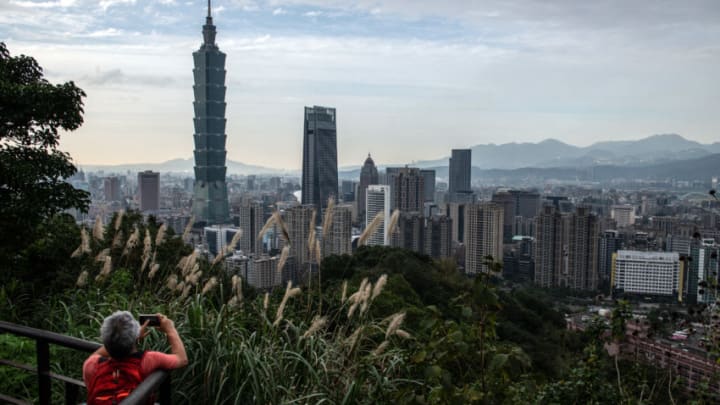 TAIPEI, TAIWAN - JANUARY 07: A man photographs the Taipei 101 tower, once the worlds tallest building, and the Taipei skyline from the top of Elephant Mountain on January 7, 2020 in Taipei, Taiwan. Taiwanese will go to the polls on Saturday after a campaign in which fake news and the looming shadow of China and its repeated threats of invasion have played a prominent role in shaping debate. Ensuring Taiwans democratic way of life has dominated an election which will be closely fought between incumbent, anti-China president Tsai Ing-wen and the more pro-Beijing challenger Han Kuo-yu. (Photo by Carl Court/Getty Images)