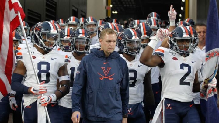 Aug 31, 2019; Pittsburgh, PA, USA; Virginia Cavaliers wide receiver Hasise Dubois (8) and head coach Bronco Mendenhall (center) and wide receiver Joe Reed (2) lead the team onto the field to play the Pittsburgh Panthers at Heinz Field. Virginia won 30-14. Mandatory Credit: Charles LeClaire-USA TODAY Sports