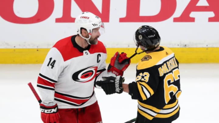 MAY 12: Justin Williams #14 of the Carolina Hurricanes pulls on the chinstrap of Brad Marchand #63 of the Boston Bruins (Photo by Adam Glanzman/Getty Images)