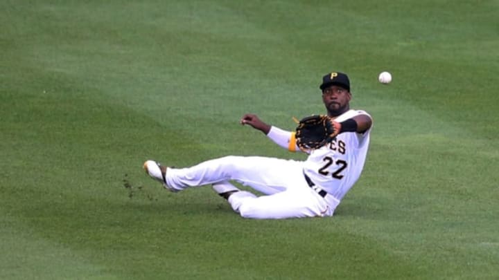 Jun 10, 2016; Pittsburgh, PA, USA; Pittsburgh Pirates center fielder Andrew McCutchen (22) makes a sliding catch of a ball hit by St. Louis Cardinals third baseman Jhonny Peralta (not pictured) during the fourth inning at PNC Park. Mandatory Credit: Charles LeClaire-USA TODAY Sports