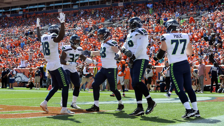 DENVER, CO – SEPTEMBER 9: Tight end Will Dissly #88 of the Seattle Seahawks celebrates with his team after scoring a touchdown against the Denver Broncos at Broncos Stadium at Mile High on September 9, 2018 in {Denver, Colorado. (Photo by Bart Young/Getty Images)