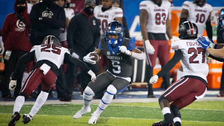 Dec 5, 2020; Lexington, Kentucky, USA; Kentucky Wildcats wide receiver Michael Drennen II runs between South Carolina Gamecocks defensive back O'Donnell Fortune (25) and defensive back Jaylan Foster (27) during the third quarter at Kroger Field. Mandatory Credit: Arden Barnes-USA TODAY Sports