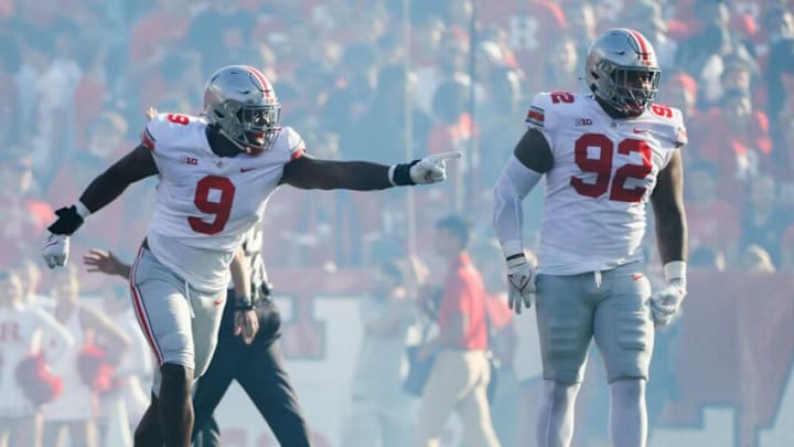 Ohio State Buckeyes defensive end Zach Harrison (9) pioints to teammate Ohio State Buckeyes defensive tackle Haskell Garrett (92) after Garrett blocked a point-after-touchdown attempt for Rutgers during the first quarter of a NCAA Division I football game between the Rutgers Scarlet Knights and the Ohio State Buckeyes on Saturday, Oct. 2, 2021 at SHI Stadium in Piscataway, New Jersey.Cfb Ohio State Buckeyes At Rutgers Scarlet Knights