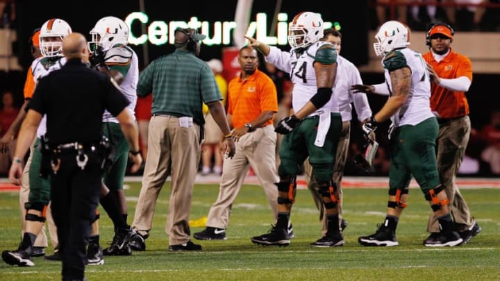 Sep 20, 2014; Lincoln, NE, USA; Miami Hurricanes coaches get their players back to the bench after a scuffle broke out with Nebraska Cornhuskers players in the second half at Memorial Stadium. Nebraska won 41-31. Mandatory Credit: Bruce Thorson-USA TODAY Sports