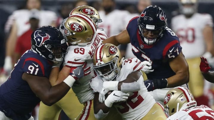 HOUSTON, TX - AUGUST 18: Joe Williams #32 of the San Francisco 49ers is tackled by Dylan Cole #51 of the Houston Texans and Brandon Dunn #92 during a preseason game at NRG Stadium on August 18, 2018 in Houston, Texas. (Photo by Bob Levey/Getty Images)