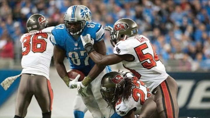 Nov 24, 2013; Detroit, MI, USA; Tampa Bay Buccaneers strong safety Mark Barron (23) and outside linebacker Lavonte David (54) tackle Detroit Lions tight end Brandon Pettigrew (87) during the game at Ford Field. Tampa Bay won 24-21. Mandatory Credit: Tim Fuller-USA TODAY Sports