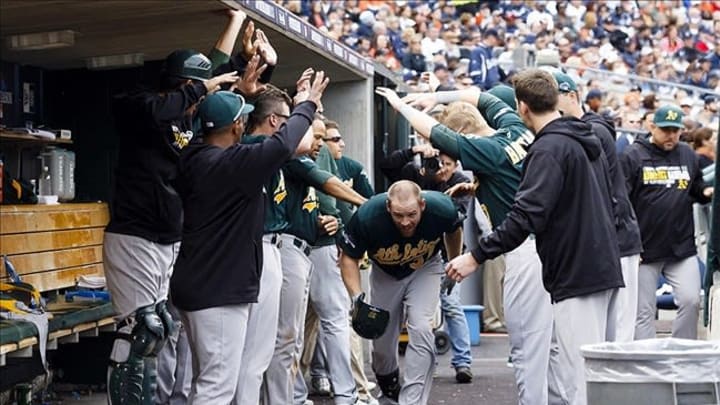 Oct 7, 2013; Detroit, MI, USA; Oakland Athletics first baseman Brandon Moss (37) receives congratulations from teammates after hitting a solo home run in the fifth inning against the Detroit Tigers in game three of the American League divisional series playoff baseball game at Comerica Park. Mandatory Credit: Rick Osentoski-USA TODAY Sports