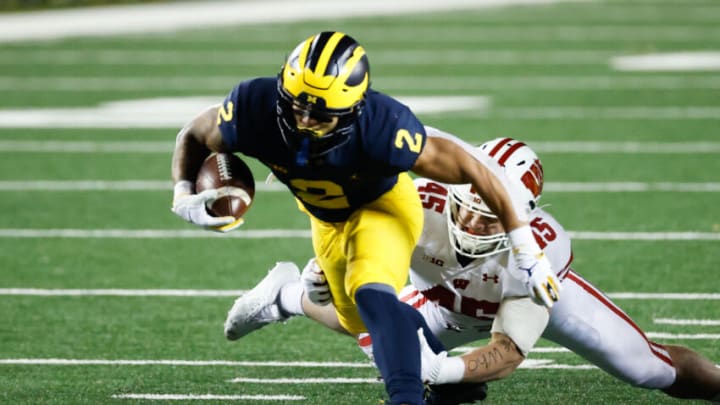 Nov 14, 2020; Ann Arbor, Michigan, USA; Michigan Wolverines running back Blake Corum (2) breaks a tackle by Wisconsin Badgers linebacker Leo Chenal (45) in the first half at Michigan Stadium. Mandatory Credit: Rick Osentoski-USA TODAY Sports