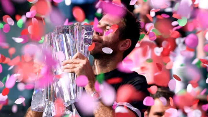 INDIAN WELLS, CA - MARCH 18: Juan Martin Del Potro of Argentina holds up the trophy in front of Roger Federer of Switzerland after his victory in the ATP final during the BNP Paribas Open at the Indian Wells Tennis Garden on March 18, 2018 in Indian Wells, California. (Photo by Harry How/Getty Images)