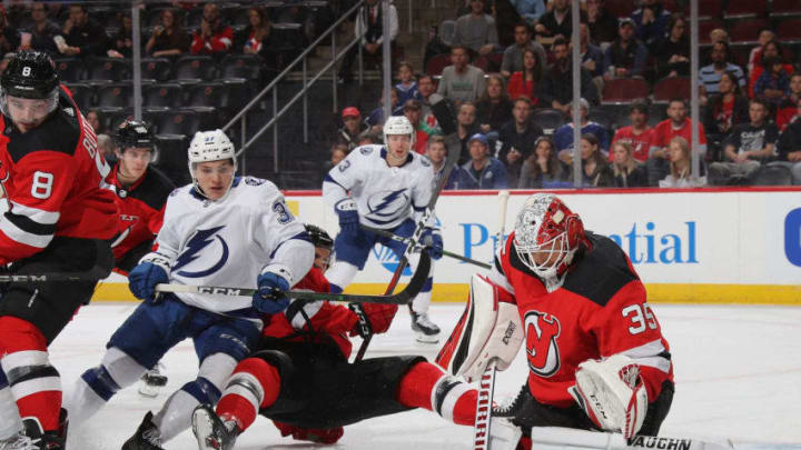 NEWARK, NEW JERSEY - OCTOBER 30: Cory Schneider #35 of the New Jersey Devils makes the first period pad save as Yanni Gourde #37 of the Tampa Bay Lightning looks for a rebound at the Prudential Center on October 30, 2019 in Newark, New Jersey. (Photo by Bruce Bennett/Getty Images)