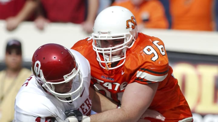 Oct 30,2004; Stillwater, Oklahoma USA; Oklahoma State Cowboy noseguard Clay Coe #96 sacks Oklahoma Sooner quarterback Jason White #18 during the second half of the game at Boone Pickens Stadium in Stillwater, Oklahoma. Oklahoma beat Oklahoma State 38-35.Mandatory Credit: Photo by Tim Heitman-USA TODAY Sports(c) Copyright 2004 Tim Heitman