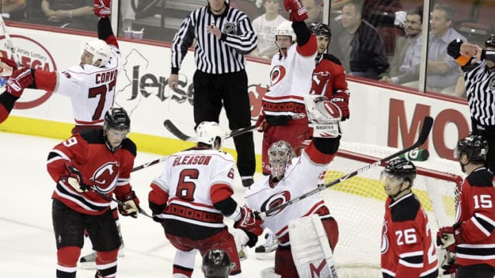 The Carolina Hurricanes' Joe Corvo (77), Eric Staal (12), Tim Gleason (6) and Cam Ward (30) celebrate as time runs out in Game 7 of an NHL playoffs series against the New Jersey Devils at the Prudential Center in Newark, New Jersey, Tuesday, April 28, 2009. The Hurricanes beat the Devils 4-3 to win the best-of-seven series, four games to three. (Photo by Chris Seward/Raleigh News & Observer/Tribune News Service via Getty Images)