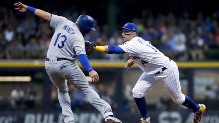 MILWAUKEE, WI - JULY 20: Hernan Perez #14 of the Milwaukee Brewers tags out Max Muncy #13 of the Los Angeles Dodgers at second base in the third inning at Miller Park on July 20, 2018 in Milwaukee, Wisconsin. (Photo by Dylan Buell/Getty Images)