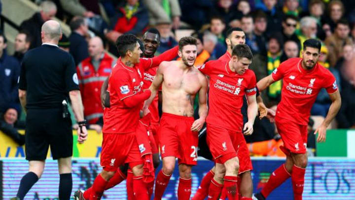 NORWICH, ENGLAND - JANUARY 23: Adam Lallana of Liverpool (without shirt) celebrates scoring his team's fifth goal with team mates during the Barclays Premier League match between Norwich City and Liverpool at Carrow Road on January 23, 2016 in Norwich, England. (Photo by Clive Mason/Getty Images)