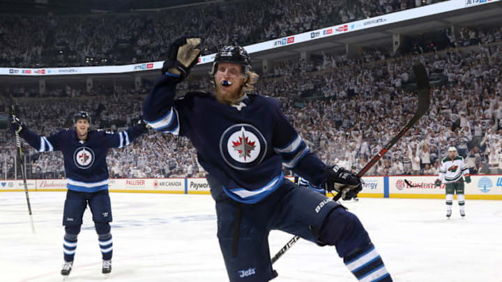 WINNIPEG, MB - APRIL 11: Patrik Laine #29 of the Winnipeg Jets celebrates a third period goal against the Minnesota Wild in Game One of the Western Conference First Round during the 2018 NHL Stanley Cup Playoffs at the Bell MTS Place on April 11, 2018 in Winnipeg, Manitoba, Canada. (Photo by Jonathan Kozub/NHLI via Getty Images)