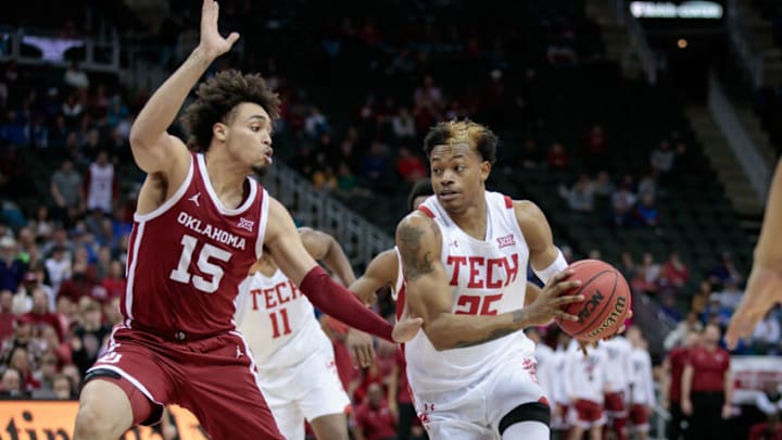 Mar 11, 2022; Kansas City, MO, USA; Texas Tech Red Raiders guard Adonis Arms (25) drives to the basket around Oklahoma Sooners forward Ethan Chargois (15) during the second half at T-Mobile Center. Mandatory Credit: William Purnell-USA TODAY Sports