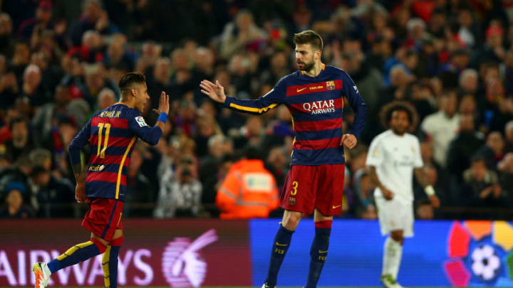 BARCELONA, SPAIN - APRIL 02: Gerard Pique of FC Barcelona celebrates with team-mate Neymar after scoring the opening goal during the La Liga match between FC Barcelona and Real Madrid CF at Camp Nou on April 2, 2016 in Barcelona, Spain. (Photo by Paul Gilham/Getty Images)