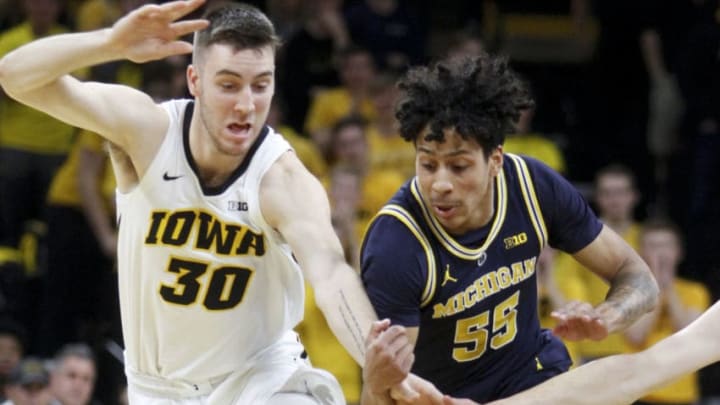 IOWA CITY, IOWA- FEBRUARY 01: Guard Eli Brooks #55 of the Michigan Wolverines chases a loose ball in the first half against guard Connor McCaffery #30 of the Iowa Hawkeyes on February 1, 2019 at Carver-Hawkeye Arena, in Iowa City, Iowa. (Photo by Matthew Holst/Getty Images)