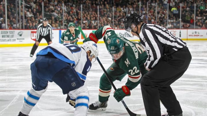 ST. PAUL, MN - NOVEMBER 23: Bryan Little #18 of the Winnipeg Jets and Nino Niederreiter #22 of the Minnesota Wild face-off during a game at Xcel Energy Center on November 23, 2018 in St. Paul, Minnesota.(Photo by Bruce Kluckhohn/NHLI via Getty Images)