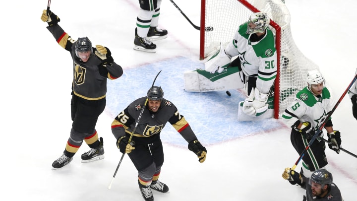 William Carrier #28 of the Vegas Golden Knights celebrates with teammates Tomas Nosek #92 and Ryan Reaves #75 after he scored the game winning goal in the third period as Ben Bishop #30 of the Dallas Stars reacts.