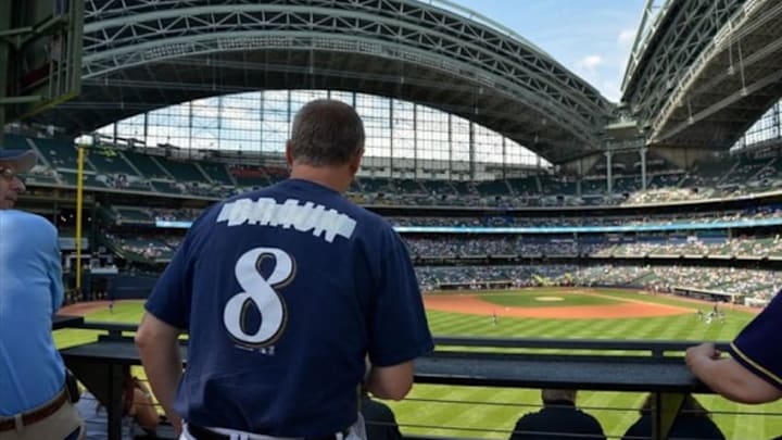 Jul 25, 2013; Milwaukee, WI, USA; Bryan Von Declan shows his disappointment for Milwaukee Brewers left fielder Ryan Braun (not pictured) by taping over the name on the back of a jersey at Miller Park after Braun was suspended for the season for violating MLB drug policies. Mandatory Credit: Benny Sieu-USA TODAY Sports