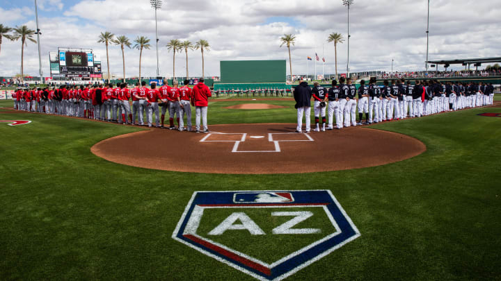 1GOODYEAR, AZ – FEBRUARY 23: Members of the Cincinnati Reds and the Cleveland Indians stand for the National Anthem before a Spring Training Game at Goodyear Ballpark on February 23, 2018 in Goodyear, Arizona. (Photo by Rob Tringali/Getty Images)