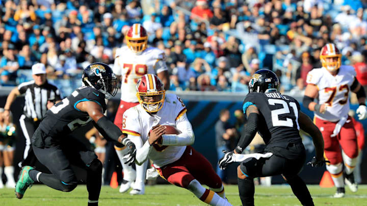 JACKSONVILLE, FLORIDA - DECEMBER 16: Josh Johnson #8 of the Washington Redskins is tackled by D.J. Hayden #25 of the Jacksonville Jaguars during the game at TIAA Bank Field on December 16, 2018 in Jacksonville, Florida. (Photo by Sam Greenwood/Getty Images)