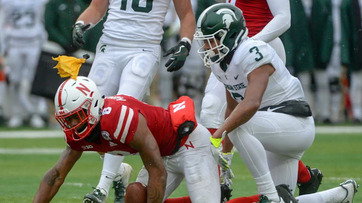 LINCOLN, NE – NOVEMBER 17: Safety Xavier Henderson #3 of the Michigan State Spartans tackles punt returner Stanley Morgan Jr. #8 of the Nebraska Cornhuskers after a fair catch call as a penalty flag is thrown in the second half at Memorial Stadium on November 17, 2018 in Lincoln, Nebraska. (Photo by Steven Branscombe/Getty Images)