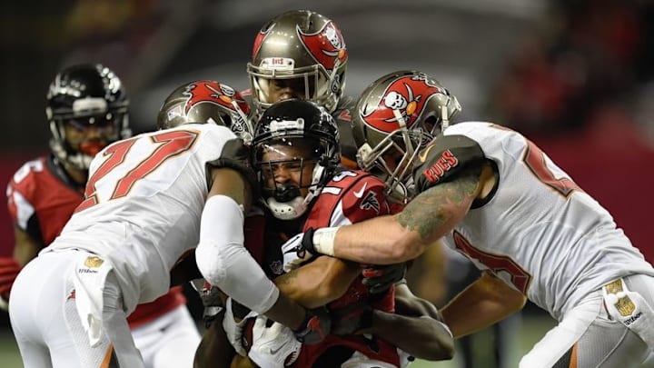 Nov 1, 2015; Atlanta, GA, USA; Tampa Bay Buccaneers cornerback Johnthan Banks (27) and strong safety Chris Conte (23) tackle Atlanta Falcons wide receiver Eric Weems (14) after a catch during the second half at the Georgia Dome. The Buccaneers defeated the Falcons 23-20 in over time. Mandatory Credit: Dale Zanine-USA TODAY Sports