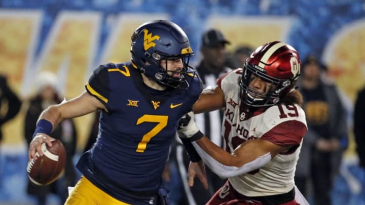 MORGANTOWN, WV - NOVEMBER 23: Caleb Kelly #19 of the Oklahoma Sooners forces Will Grier #7 of the West Virginia Mountaineers to fumble the football on November 23, 2018 at Mountaineer Field in Morgantown, West Virginia. (Photo by Justin K. Aller/Getty Images)