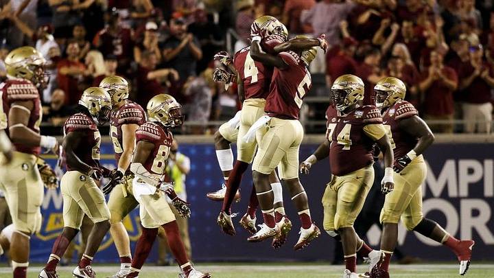 Sep 5, 2016; Orlando, FL, USA; Florida State Seminoles defensive back Tarvarus McFadden (4) celebrates with Florida State Seminoles linebacker Dontavious Jackson (5) after a interception in the fourth quarter at Camping World Stadium. Florida State Seminoles won 45-34. Mandatory Credit: Logan Bowles-USA TODAY Sports