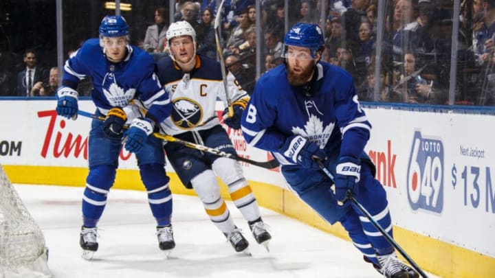 TORONTO, ON - FEBRUARY 25: Jake Muzzin #8 and Travis Dermott #23 of the Toronto Maple Leafs skate against Jack Eichel #9 of the Buffalo Sabres during the second period at the Scotiabank Arena on February 25, 2019 in Toronto, Ontario, Canada. (Photo by Mark Blinch/NHLI via Getty Images)