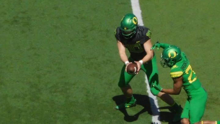 Oregon Football Quarterback Justin Herbert hands the ball off during the Spring Game.Justin Phillips/KPNW Sports