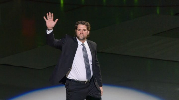 Jan 28, 2022; Dallas, Texas, USA; Former Dallas Stars player Derian Hatcher waves to the crowd before the ceremony to have the jersey number of former Stars player Sergei Zubov number retired retired before the game between the Dallas Stars and the Washington Capitals at American Airlines Center. Mandatory Credit: Jerome Miron-USA TODAY Sports