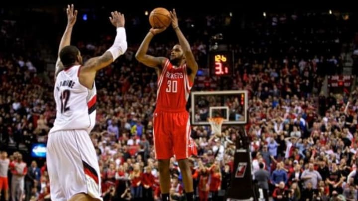 Apr 25, 2014; Portland, OR, USA; Houston Rockets guard Troy Daniels (30) makes a three point basket over Portland Trail Blazers forward LaMarcus Aldridge (12) with 12 seconds left in overtime to win game three of the first round of the 2014 NBA Playoffs at the Moda Center. Mandatory Credit: Craig Mitchelldyer-USA TODAY Sports