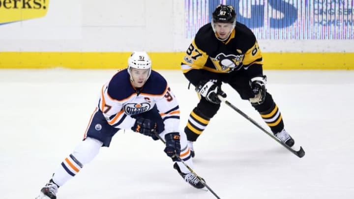PITTSBURGH, PA - OCTOBER 24: Edmonton Oilers Center Connor McDavid (97) skates with the puck ahead of Pittsburgh Penguins center Sidney Crosby (87) during the first period in the NHL game between the Pittsburgh Penguins and the Edmonton Oilers on October 24, 2017, at PPG Paints Arena in Pittsburgh, PA. (Photo by Jeanine Leech/Icon Sportswire via Getty Images)