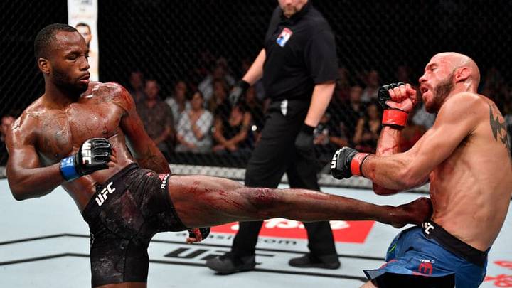 SINGAPORE - JUNE 23: (L-R) Leon Edwards of Jamaica kicks Donald Cerrone in their welterweight bout during the UFC Fight Night event at the Singapore Indoor Stadium on June 23, 2018 in Singapore. (Photo by Jeff Bottari/Zuffa LLC/Zuffa LLC via Getty Images)
