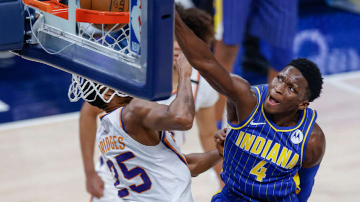 INDIANAPOLIS, IN - JANUARY 09: Victor Oladipo #4 of the Indiana Pacers goes up for the dunk against Mikal Bridges #25 of the Phoenix Suns during the second half at Bankers Life Fieldhouse on January 9, 2021 in Indianapolis, Indiana. NOTE TO USER: User expressly acknowledges and agrees that, by downloading and or using this photograph, User is consenting to the terms and conditions of the Getty Images License Agreement. (Photo by Michael Hickey/Getty Images)