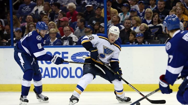 Feb 14, 2016; Tampa, FL, USA; St. Louis Blues center Paul Stastny (26) passes the puck as Tampa Bay Lightning center Steven Stamkos (91) defends during the third period at Amalie Arena. St. Louis defeated Tampa Bay 2-1. Mandatory Credit: Kim Klement-USA TODAY Sports