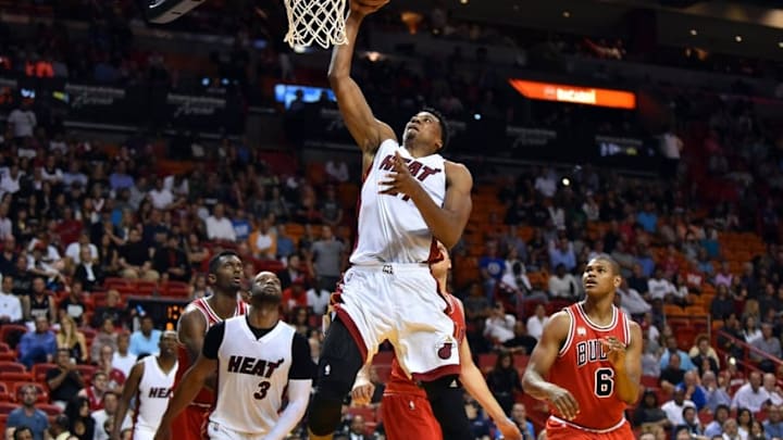 Mar 1, 2016; Miami, FL, USA; Miami Heat center Hassan Whiteside (21) dunks the ball as Chicago Bulls forward Cristiano Felicio (6) looks on during the second half at American Airlines Arena. The Heat won 129-111. Mandatory Credit: Steve Mitchell-USA TODAY Sports