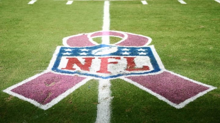 Oct 9, 2016; Miami Gardens, FL, USA; An NFL logo is seen on the field with a pink ribbon in honor of breast care awareness month after a game between the Tennessee Titans and the Miami Dolphins at Hard Rock Stadium. Titans won 30-17. Mandatory Credit: Steve Mitchell-USA TODAY Sports