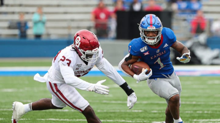 Oct 5, 2019; Lawrence, KS, USA; Kansas Jayhawks running back Pooka Williams Jr. (1) runs against Oklahoma Sooners linebacker DaShaun White (23) at David Booth Kansas Memorial Stadium. Mandatory Credit: Jay Biggerstaff-USA TODAY Sports