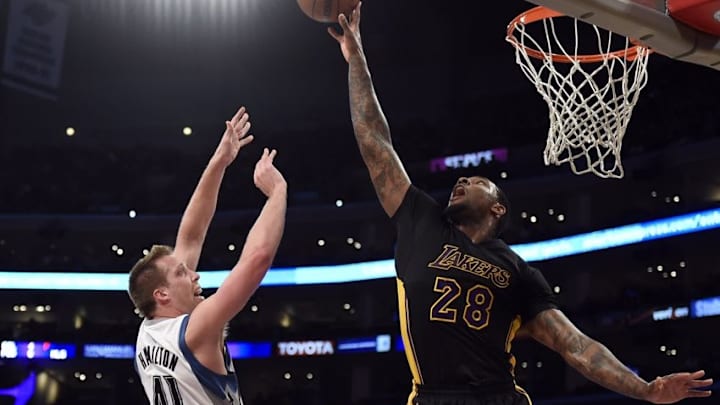 Apr 10, 2015; Los Angeles, CA, USA; Los Angeles Lakers forward Tarik Black (28) defends against Minnesota Timberwolves center Justin Hamilton (41) during the first half at Staples Center. Mandatory Credit: Richard Mackson-USA TODAY Sports
