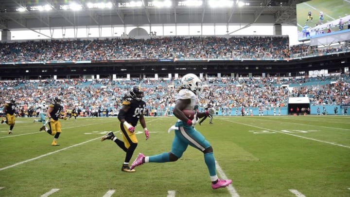 Oct 16, 2016; Miami Gardens, FL, USA; Miami Dolphins running back Jay Ajayi (23) runs past Pittsburgh Steelers outside linebacker Jarvis Jones (95) for a touchdown during the second half at Hard Rock Stadium. The Dolphins won 30-15. Mandatory Credit: Steve Mitchell-USA TODAY Sports