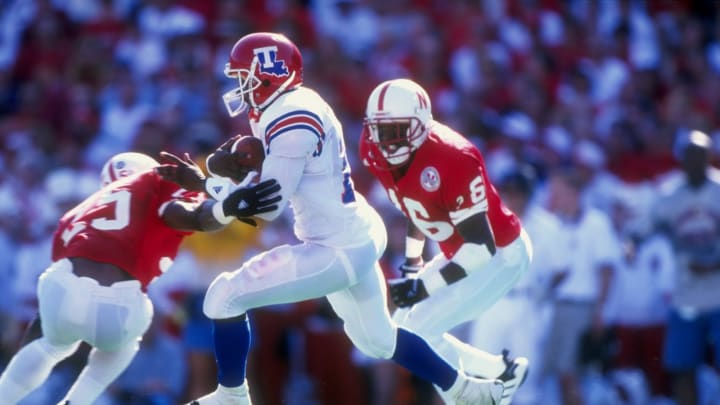 23 Aug 1998: Wide receiver Troy Edwards #16 of the Louisiana Tech Bulldogs grips the ball as he avoids being tackled during the Eddie Robison Classic game against the Nebraska Cornhuskers at Tom Osborne Field in Lincoln, Nebraska. Nebraska defeated Louis
