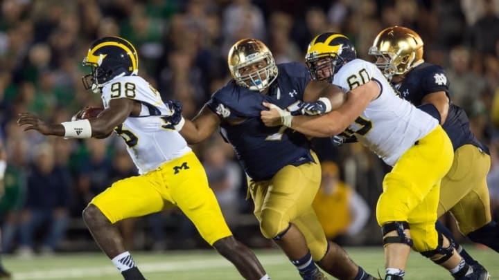 Sep 6, 2014; South Bend, IN, USA; Michigan Wolverines quarterback Devin Gardner (98) attempts to escape pressure from Notre Dame Fighting Irish defensive lineman Daniel Cage (75) in the fourth quarter at Notre Dame Stadium. Notre Dame won 31-0. Mandatory Credit: Matt Cashore-USA TODAY Sports