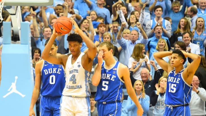 Mar 4, 2017; Chapel Hill, NC, USA; North Carolina Tar Heels forward Isaiah Hicks (4) holds up the ball as Duke Blue Devils forward Jayson Tatum (0), guard Luke Kennard (5) and guard Frank Jackson (15) react near the end of the game. The Tar Heels defeated the Blue Devils 90-83 at Dean E. Smith Center. Mandatory Credit: Bob Donnan-USA TODAY Sports