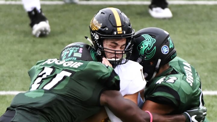 CHARLOTTE, NC – OCTOBER 27: Quarterback Jack Abraham #15 of the Southern Miss Golden Eagles takes a hit from linebacker Juwan Foggie #21 and linebacker Henry Segura #42 of the Charlotte 49ers during the football game at Jerry Richardson Stadium on October 27, 2018 in Charlotte, North Carolina. (Photo by Mike Comer/Getty Images)