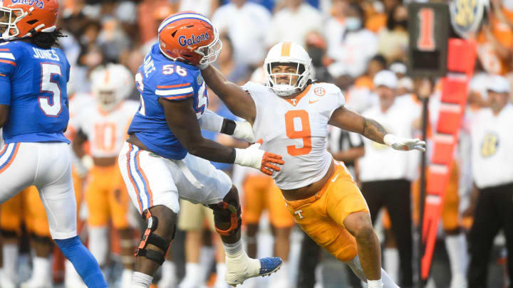 Tennessee linebacker Tyler Baron (9) grabs ahold of Florida offensive lineman Jean Delance (56) during the first quarter of an NCAA football game against Florida at Ben Hill Griffin Stadium in Gainesville, Florida on Saturday, Sept. 25, 2021.Tennflorida0925 0940